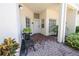 Welcoming front porch with brick flooring and a cozy seating area at 14840 Shipwatch Trce # 1924, Largo, FL 33774