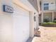 Attached one-car garage with address signage and brick paved driveway at 14840 Shipwatch Trce # 1924, Largo, FL 33774