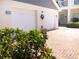 Well-maintained two-car garage with updated doors and landscaping at 14840 Shipwatch Trce # 1924, Largo, FL 33774