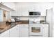 Modern kitchen with white cabinets and stainless appliances at 14840 Shipwatch Trce # 1924, Largo, FL 33774