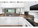 Modern kitchen featuring granite countertops, white appliances, and a bright, open layout at 14840 Shipwatch Trce # 1924, Largo, FL 33774