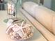 Seashell decor displayed in a glass bowl on a bright white table adds to the coastal theme at 14840 Shipwatch Trce # 1924, Largo, FL 33774