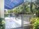 Relaxing outdoor patio with shade awning, surrounded by lush tropical foliage at 14840 Shipwatch Trce # 1924, Largo, FL 33774