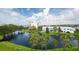 Beautiful community pond view with a fountain, surrounded by lush palm trees and nearby residences on a sunny day at 14840 Shipwatch Trce # 1924, Largo, FL 33774
