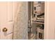 Small storage room featuring water heater and HVAC components inside the house at 14840 Shipwatch Trce # 1924, Largo, FL 33774