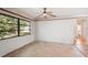 Spacious bedroom with neutral walls, tile flooring, and a bright window, creating a versatile living space at 1521 Fireside St, Port Charlotte, FL 33952