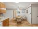 Dining space adjacent to kitchen with wooden table, patterned chairs, and wood laminate floors at 1521 Fireside St, Port Charlotte, FL 33952