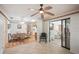 Bright dining room adjacent to living spaces, featuring hardwood floors and natural light from sliding glass doors at 1521 Fireside St, Port Charlotte, FL 33952