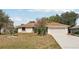Charming single-story home with an attached two-car garage and well-maintained landscaping at 1521 Fireside St, Port Charlotte, FL 33952
