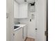 This laundry room features a washer and dryer, and overhead storage cabinets at 1521 Fireside St, Port Charlotte, FL 33952