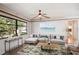 Inviting living room featuring a comfortable sectional sofa, stylish rug, and scenic view through the large window at 1521 Fireside St, Port Charlotte, FL 33952