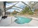 This pool features a screened in enclosure, patio and diving board at 1521 Fireside St, Port Charlotte, FL 33952