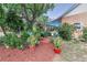 Inviting backyard featuring lush landscaping and a covered patio perfect for outdoor relaxation and entertaining at 15625 Olney Ln, Spring Hill, FL 34610