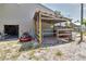 Functional barn features an open stable area and a grassy lawn with lawnmower at 15625 Olney Ln, Spring Hill, FL 34610