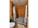 Rustic bathroom featuring wood-paneled walls and a galvanized steel tub with a unique shower curtain at 15625 Olney Ln, Spring Hill, FL 34610