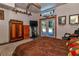 Bright bedroom showcasing an entertainment center, french doors, and neutral colors at 15625 Olney Ln, Spring Hill, FL 34610
