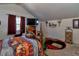 Comfortable bedroom with a sloped ceiling, a large window, and unique equestrian decorations at 15625 Olney Ln, Spring Hill, FL 34610
