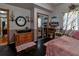 Inviting bedroom with a decorative cabinet, mirrored closet, and a plush pink bedspread at 15625 Olney Ln, Spring Hill, FL 34610