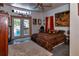 Bedroom featuring a ceiling fan, french doors leading to a backyard, and unique decor at 15625 Olney Ln, Spring Hill, FL 34610
