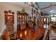 Dining room with a large wooden table and chairs, adjacent to a display cabinet at 15625 Olney Ln, Spring Hill, FL 34610