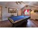 Entertaining game room featuring a pool table, exposed beams, and natural light at 15625 Olney Ln, Spring Hill, FL 34610