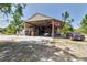 Spacious garage area, revealing a car and various vehicles stored beneath the wide, covered structure at 15625 Olney Ln, Spring Hill, FL 34610