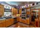 Kitchen with wood cabinetry, stainless appliances, and an eat-in area at 15625 Olney Ln, Spring Hill, FL 34610