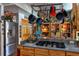 Kitchen counter with stainless steel appliances, gray counters, and hanging pot rack at 15625 Olney Ln, Spring Hill, FL 34610