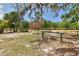 Expansive grassy area with mature trees and wooden fencing, providing privacy and a park-like setting at 15625 Olney Ln, Spring Hill, FL 34610