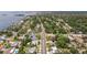High aerial view of residences with nearby ocean and tree-lined streets at 1579 Bayshore Blvd, Dunedin, FL 34698