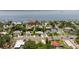 Aerial view showcasing residential neighborhood homes with a coast and water backdrop at 1579 Bayshore Blvd, Dunedin, FL 34698