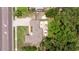 A bird's eye view of a home featuring a stone patio, a canopy, and lush landscaping at 1579 Bayshore Blvd, Dunedin, FL 34698