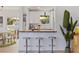Charming bar with counter seating, seamlessly connects the living room and kitchen at 1579 Bayshore Blvd, Dunedin, FL 34698