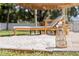 Beach themed lounge area with a beach umbrella, creating a relaxing outdoor retreat in the backyard at 1579 Bayshore Blvd, Dunedin, FL 34698