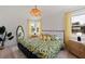 Tasteful bedroom with unique floral bedding, rattan furniture, and yellow curtains at 1579 Bayshore Blvd, Dunedin, FL 34698