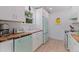 Bright kitchen featuring white cabinets, a decorative wood countertop, and retro style appliances at 1579 Bayshore Blvd, Dunedin, FL 34698