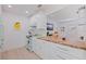 Bright kitchen featuring white cabinets, a decorative wood countertop, and stainless appliances at 1579 Bayshore Blvd, Dunedin, FL 34698