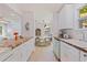 Bright kitchen featuring white cabinets, a decorative wood countertop, stainless appliances, and an open floorplan at 1579 Bayshore Blvd, Dunedin, FL 34698