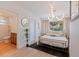 Bright main bedroom with a gold bed frame, modern light fixture, and ensuite bathroom featuring upscale finishes at 1579 Bayshore Blvd, Dunedin, FL 34698
