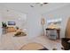 Bright office space with wooden desk, surfboard, and natural light, creating a relaxed workspace in this home at 1579 Bayshore Blvd, Dunedin, FL 34698
