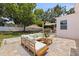 Backyard patio with comfortable seating, a dining table, and an outdoor kitchen, perfect for relaxing and entertaining at 1579 Bayshore Blvd, Dunedin, FL 34698