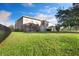 Large backyard with well-maintained lawn and a black metal fence at 16016 Persimmon Grove Dr, Lithia, FL 33547