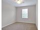 Neutral bedroom with a ceiling fan and window for natural light at 16016 Persimmon Grove Dr, Lithia, FL 33547