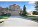 Two-story home featuring a large driveway, manicured lawn, and a neutral color palette exterior at 16016 Persimmon Grove Dr, Lithia, FL 33547