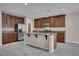 Modern kitchen boasts stainless appliances, granite countertops, ample cabinetry, and a functional center island at 16016 Persimmon Grove Dr, Lithia, FL 33547