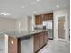 Well-lit kitchen with stainless steel appliances, granite countertops, and wood cabinetry at 16016 Persimmon Grove Dr, Lithia, FL 33547