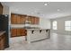 Modern kitchen featuring stainless steel appliances, granite countertops, an island, and ample cabinet space at 16016 Persimmon Grove Dr, Lithia, FL 33547