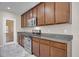 Kitchen featuring stainless steel appliances, granite countertops, and ample wooden cabinetry for efficient meal preparation at 16016 Persimmon Grove Dr, Lithia, FL 33547