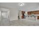 Expansive living area featuring tile flooring, neutral walls, stairway access, and seamless transition to a modern kitchen at 16016 Persimmon Grove Dr, Lithia, FL 33547