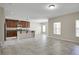 Open-concept living room with tile floors, plenty of natural light, and a kitchen with stainless steel appliances at 16016 Persimmon Grove Dr, Lithia, FL 33547